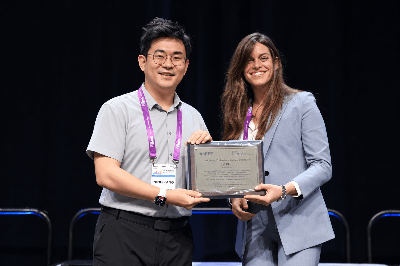 Ning Kang receiving his Young Professional Paper Competition award at EMBC 2026